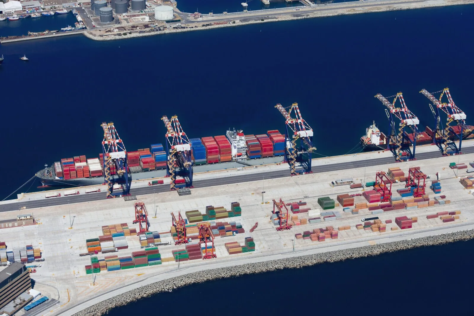 Container vessel berthed at a terminal under gantry cranes